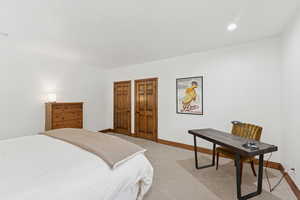 Carpeted bedroom with baseboards and recessed lighting
