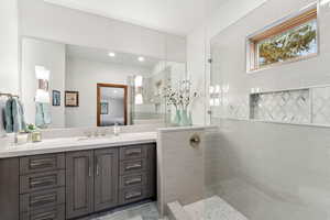 Full bathroom featuring vanity, walk in shower, and ensuite bathroom