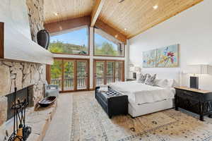 Carpeted bedroom featuring high vaulted ceiling, access to exterior, a wooden ceiling with exposed beams, a fireplace, and recessed lighting