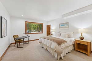 Bedroom with recessed lighting and light carpet