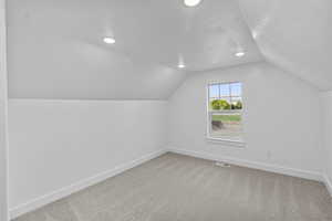 Bedroom 3 light carpet and lofted ceiling