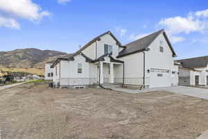 View of front of home with driveway and a garage