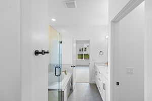 Bathroom with vanity, a shower stall, a bath, light tile patterned floors, and recessed lighting