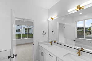 Full bath with double vanity and a garden tub