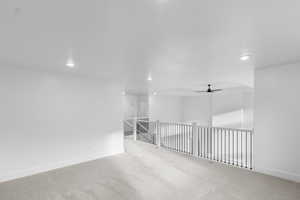 Loft with carpet flooring, recessed lighting, and ceiling fan