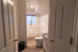 Half bath featuring vanity and light wood-style flooring