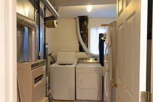 Laundry room with separate washer and dryer and heating unit