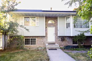 Doorway to property with brick siding and solar panels