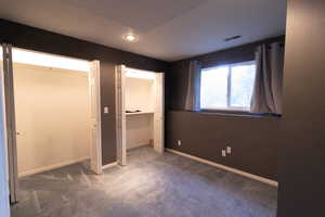 Unfurnished bedroom featuring carpet and recessed lighting