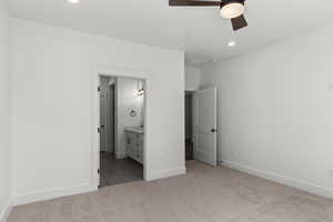 Unfurnished bedroom with recessed lighting, light carpet, ensuite bath, a ceiling fan, and light tile patterned floors