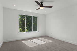 Spare room featuring carpet flooring, a ceiling fan, and recessed lighting