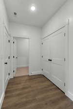 Hallway featuring dark wood-style flooring