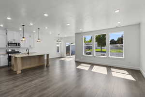 Unfurnished living room with recessed lighting and dark wood-type flooring