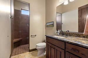 Bathroom with vanity and a tile shower
