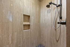 Full bath featuring tiled shower