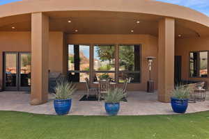 Property entrance featuring a patio and stucco siding