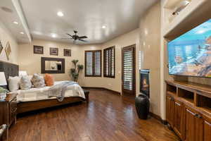 Bedroom with dark wood-style flooring, access to outside, a high end fireplace, recessed lighting, and a ceiling fan