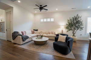 Living room with recessed lighting, dark wood-style floors, and ceiling fan