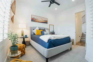 Bedroom with a ceiling fan and recessed lighting