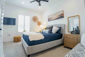 Carpeted bedroom featuring multiple windows, a ceiling fan, and recessed lighting