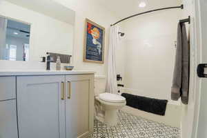 Bathroom featuring shower / tub combo with curtain, vanity, recessed lighting, and light tile patterned flooring