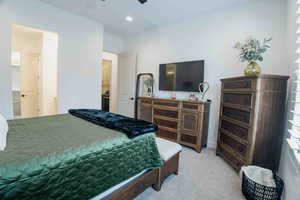 Bedroom with light colored carpet and recessed lighting