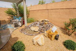 Fenced backyard featuring a pergola and a patio area