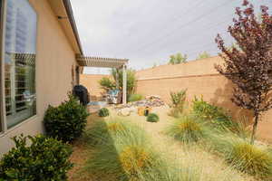 Fenced backyard featuring a patio and a pergola