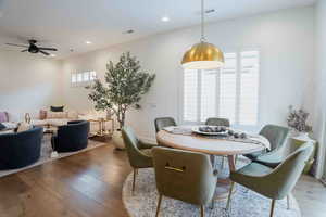 Dining area with hardwood / wood-style flooring, recessed lighting, and a ceiling fan