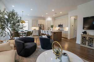 Living room featuring dark wood-type flooring and recessed lighting