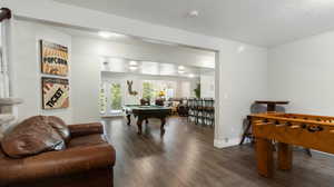Rec room with billiards, dark wood finished floors, french doors, and a textured ceiling