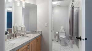 Jack and Jill  bathroom featuring vanity, light tile patterned floors, and a textured ceiling