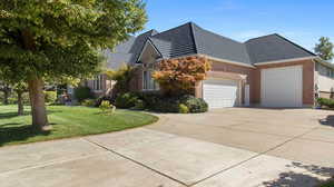 View of property exterior featuring an attached garage, Extra height and length on 2nd bay that is double deep in length for two vehicles or boat, RV or toys, concrete driveway, a lawn, and brick siding