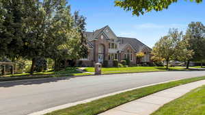 View of front of property featuring a front yard and brick siding