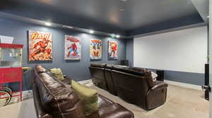 Carpeted cinema room with recessed lighting and a raised ceiling