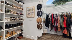 Owner's suite includes two walk-in closets- this is the larger one with natural light, pull down hanging sections to use full height. Upgraded flooring.