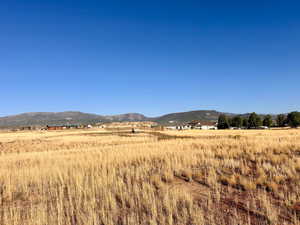 View of mountain backdrop featuring rural landscape