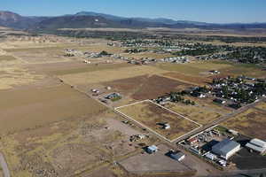 Aerial view of property's location with a mountainous background and rural landscape