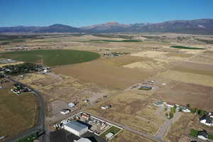 Aerial view of property's location with rural landscape and a mountainous background