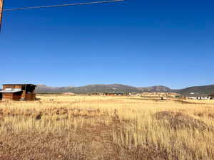 View of mountain backdrop featuring rural landscape