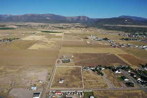 Aerial overview of property's location with a mountain backdrop and rural landscape