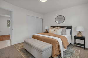 Carpeted bedroom with closet