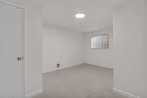 Basement bedroom featuring new carpet