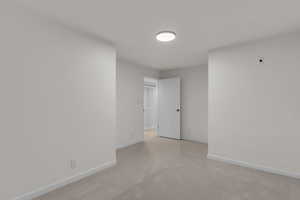 Basement bedroom featuring new carpet