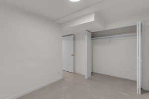 Unfurnished bedroom featuring carpet flooring and a closet