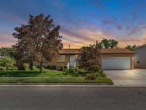 View of front facade with driveway, RV parking and an attached garage