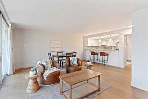 Living room featuring light wood-type flooring and baseboards