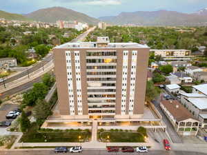 View of building exterior featuring a mountain view and a view of city