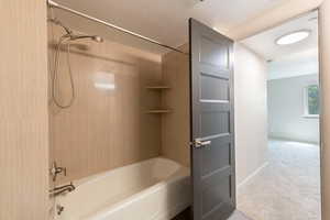 Full bath with bathtub / shower combination and a textured ceiling