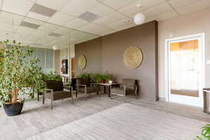 Common area with a paneled ceiling